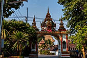 Vientiane, Laos - Pha That Luang, Other structures on the ground include a bell tower, several stupas, a number of pavilions sheltering images of the Buddha.  